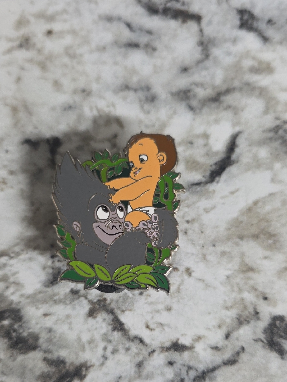 2024 Disney Parks open edition pin featuring Terk holding baby Tarzan